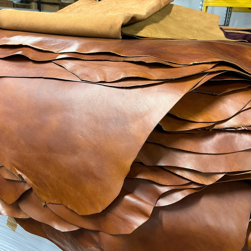 Floto full grain vegetable tanned leather hides in a stack on a pallet