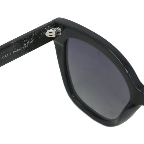 Black sunglasses with a clear lens on a white background
