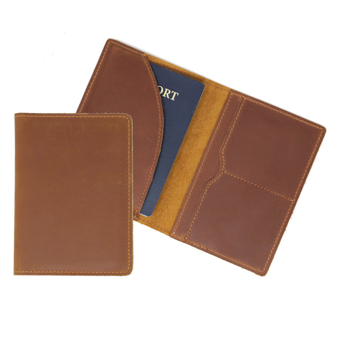 Brown leather passport holder with a blue passport inside on a white background