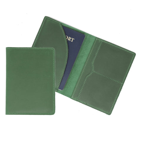 Green leather passport holder with a blue passport inside on a white background