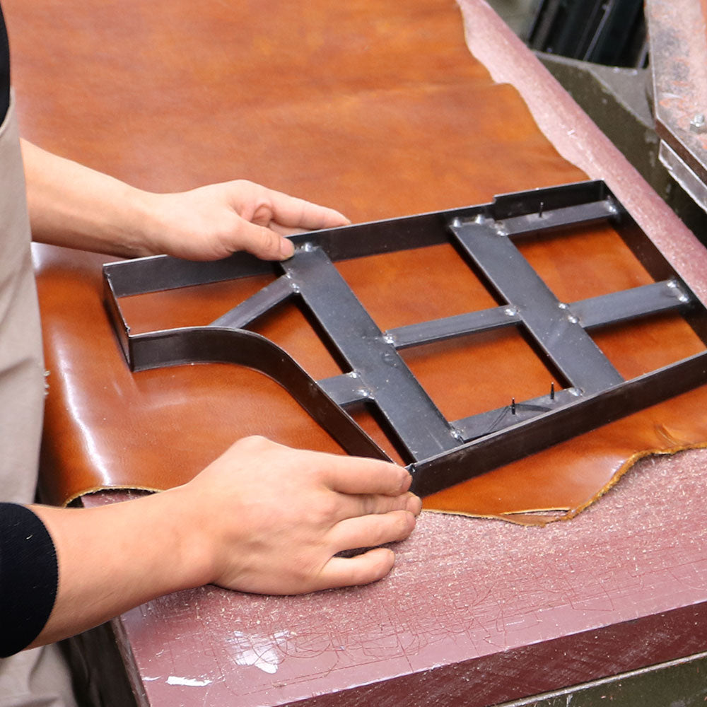 Come take a tour of the Floto leather factory in the heart of Tuscany to get a glimpse of our production process.  In this picture a Floto leathersmith artisan is using a clicker press and die to cut leather panels.