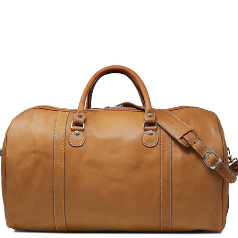 The Floto Parma Duffle Bag is a leather weekender that is handcrafted in Italy with our famous Parma leather. Parma leather is tanned in a special way with no chemicals so the bag will get better as it ages - each travel bag takes on a unique look and darkens like a saddle over time. Parma is leather tanning the natural way. 2