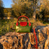 Floto Gattane Green handbag with brown handles and strap on a stone surface with a natural background
