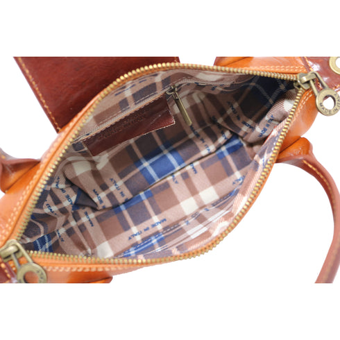 Floto Gattane Close-up of an open brown handbag with plaid interior lining.