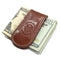 Brown leather money clip on top of U.S. currency with a visible brand logo.