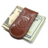 Brown leather money clip on top of U.S. currency with a visible brand logo.