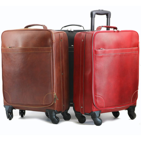 Brown and red leather suitcases with wheels on a white background