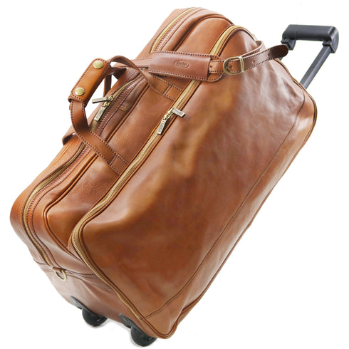 Brown leather suitcase with wheels on a white background