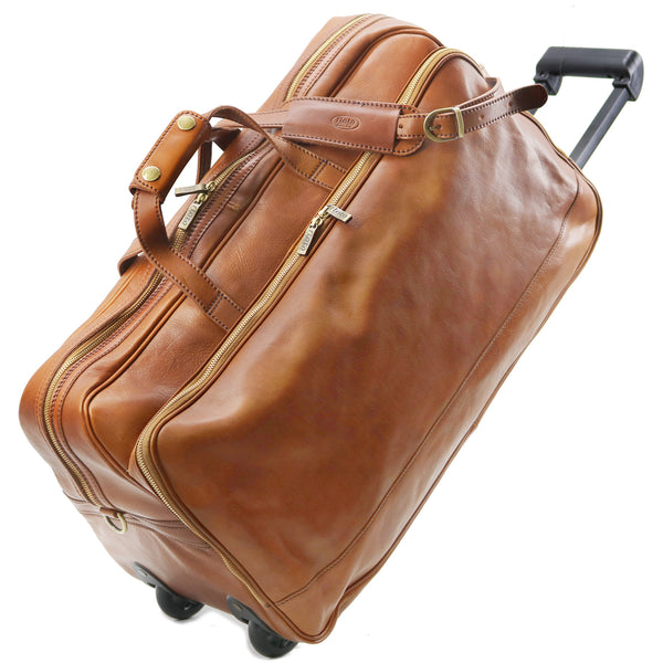 Brown leather suitcase with wheels on a white background