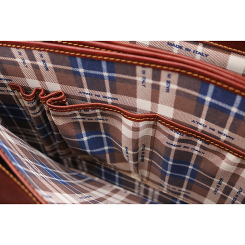 Close-up of a plaid fabric with visible stitching and 'Made in Italy' label.