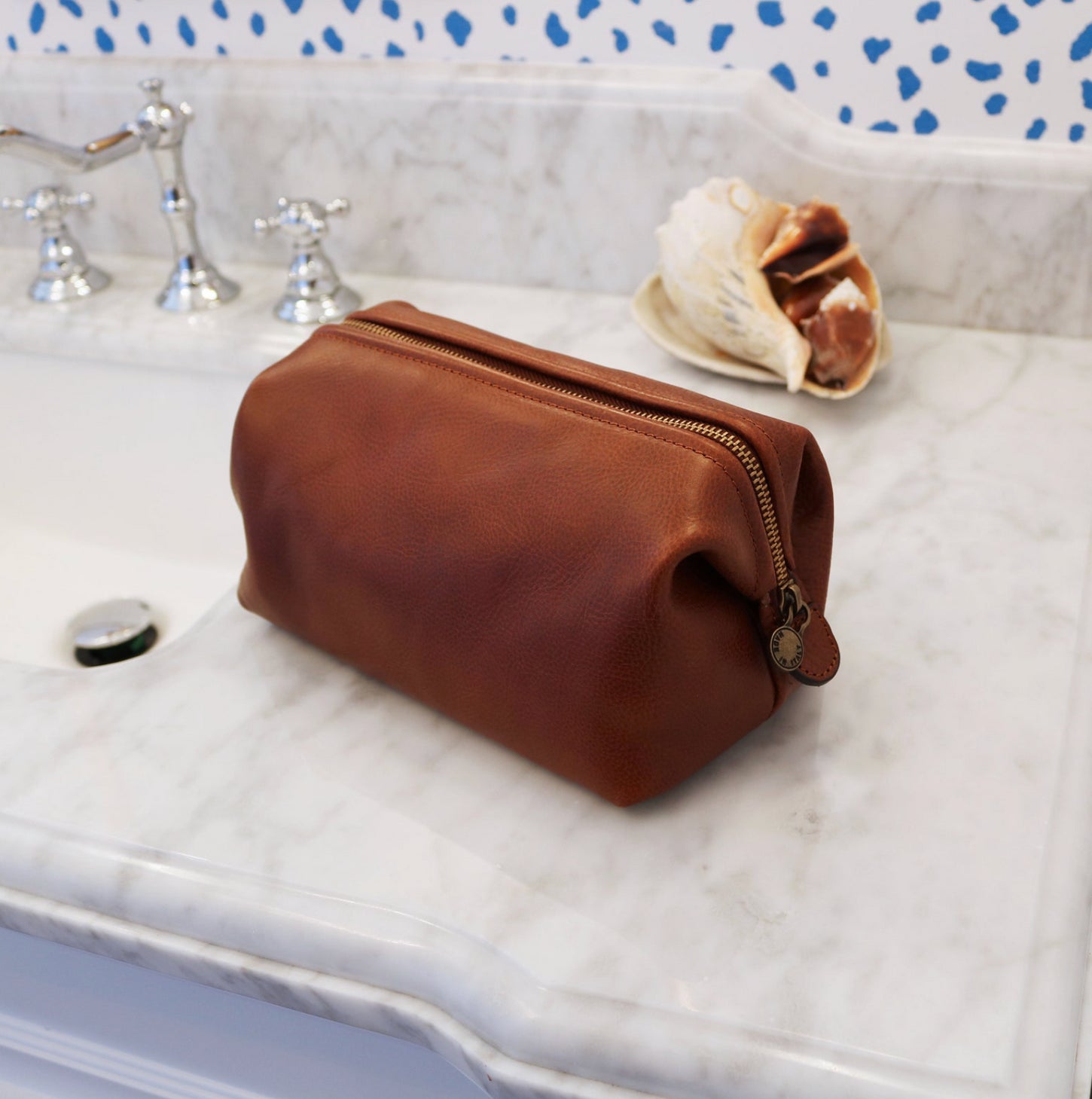 This is our women's make-up bag shop. Pictured is a Floto Collection Travel Kit that is on a sink in a hotel bathroom on the island of Sardinia, Italy. Visit our women's toiletry bag store now.