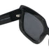 Black sunglasses with a reflective lens on a white background