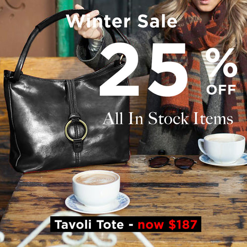 Black tote bag on a table with coffee cups, promotional text for winter sale and discount on Tavoli Tote.