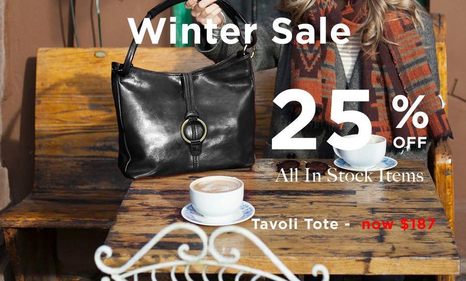 Black tote bag on a wooden bench with a winter sale advertisement.