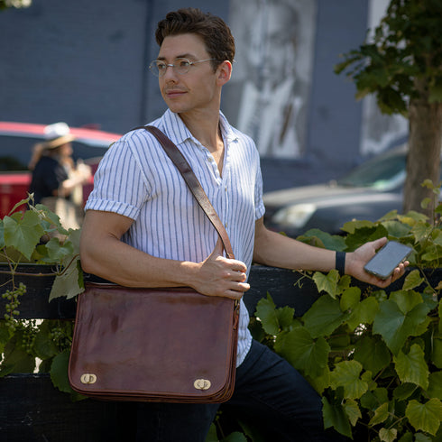 The Floto Roma Messenger Bag is a soft-sided leather bag that is made in Italy with full grain hand-stained leather. This messenger bag has an outside zip pocket, inside pen organizer, and a detachable shoulder strap. This is the Roma Messenger in Vecchio Brown 12