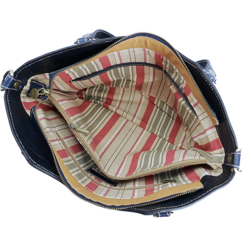 The Floto Ischia Shoulder Bag is a women's leather bag that is handcrafted in Italy. It has comfortable shoulder straps that are adjustable and includes a detachable crossbody strap. This is the Ischia Shoulder Bag in Blue. 4